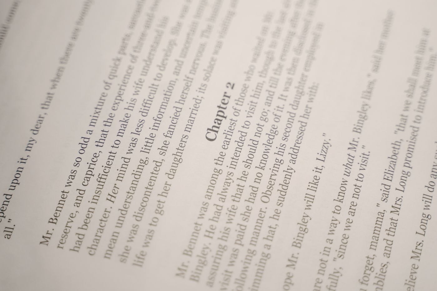 An open book shows a chapter break and the beginning of chapter two.