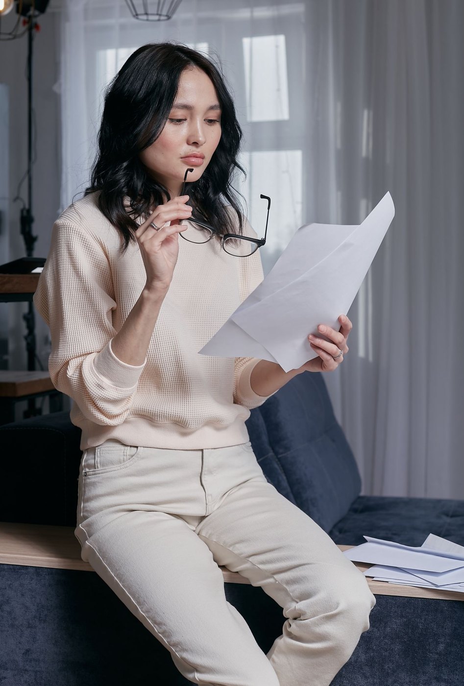 A reader studies loose printed pages at home.