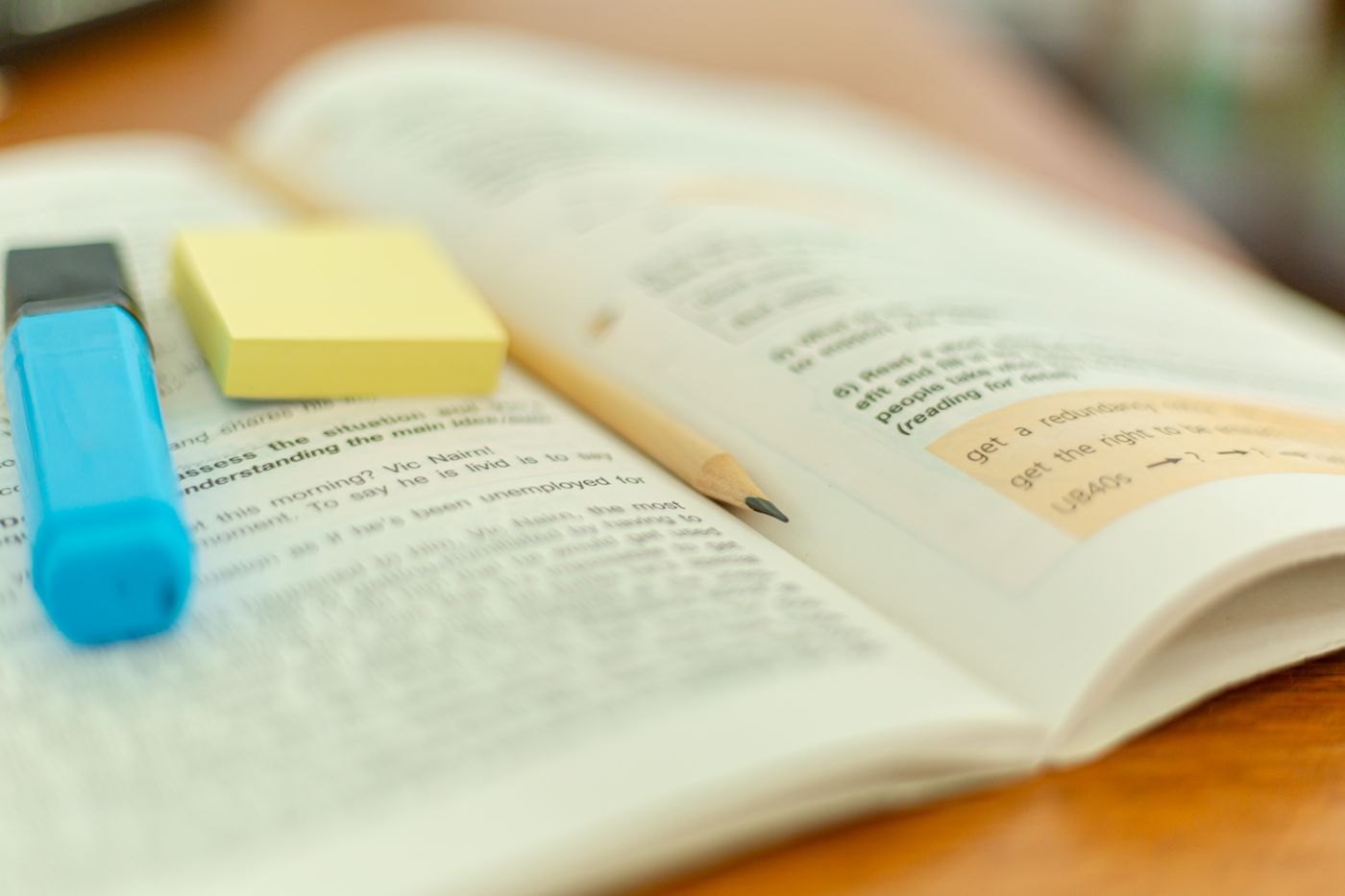 A reference book marked with a highlighter and sticky notes.