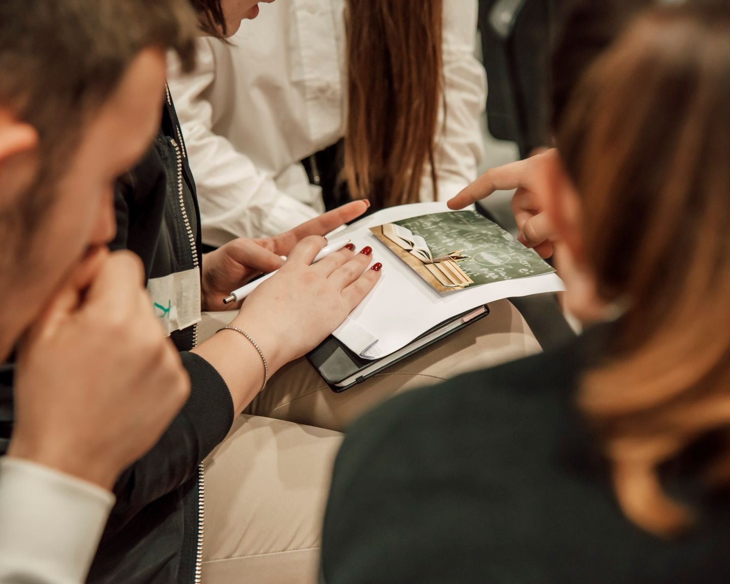 Readers gathered around an open illustrated book.