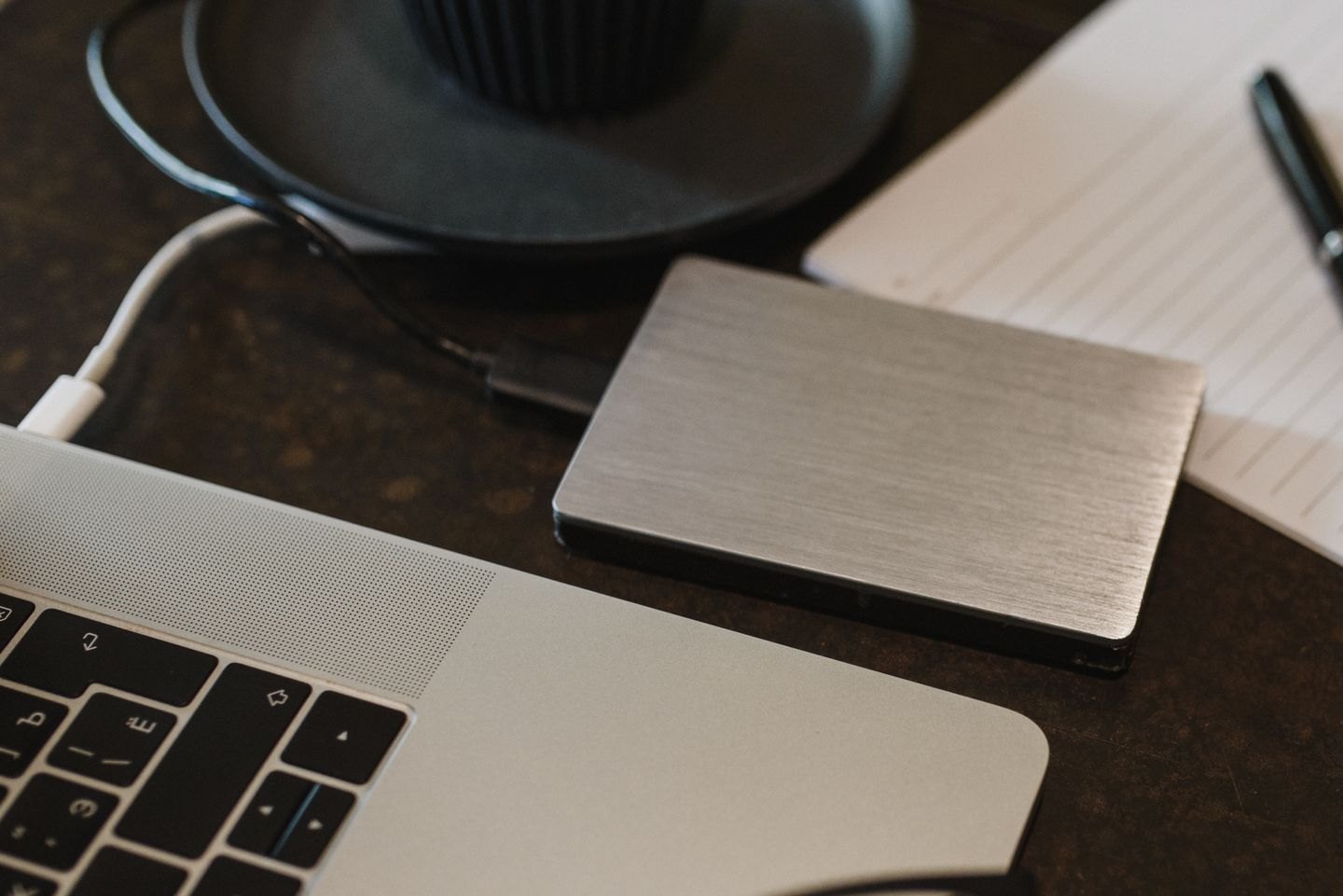 An external storage drive connected to a laptop.